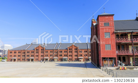 Red brick warehouse, blue sky and white clouds Red brick warehouse, blue sky and white clouds 130210616