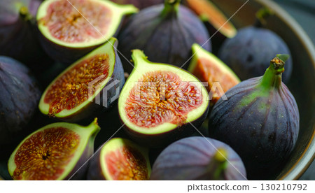 Rustic style fresh figs sliced open, autumn fruit showing detailed interior texture Rustic style fresh figs sliced open, autumn fruit showing detailed interior texture 130210792