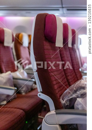 Interior view of airplane seats, viewed inside the cabin 130210835