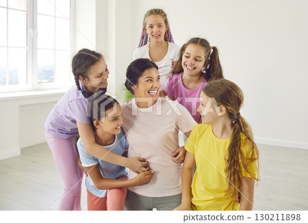 Group of happy children having fun together with their sports trainer or dance teacher 130211898