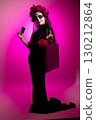 Girl Dressed for Dia De Muertos Holds Phone and Shopping Bag 130212864