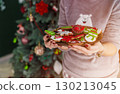 Beautiful Redhead Woman Holding Plate with Cakes 130213045