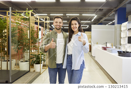 Happy Married Couple Giving Thumbs Up in Plumbing Store Happy Married Couple Giving Thumbs Up in Plumbing Store 130213415