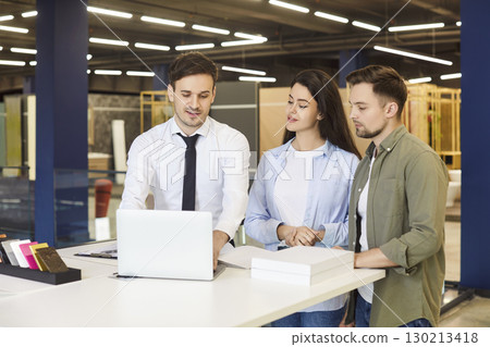 Salesman Consulting Young Couple in Hardware Store 130213418