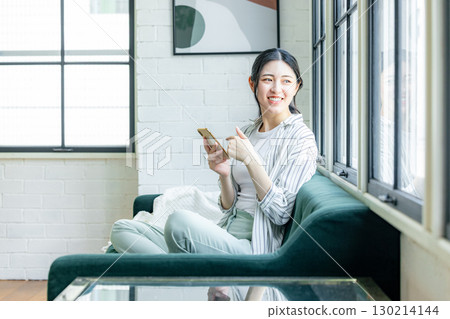 A woman relaxing on the sofa 130214144