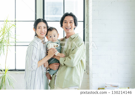 Smiling family holding a baby Smiling family holding a baby 130214146