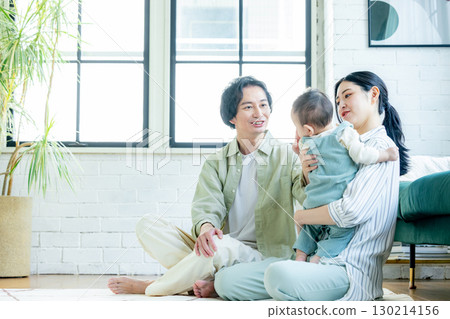 A family relaxing in the living room A family relaxing in the living room 130214156