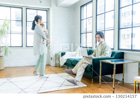 A young family relaxing in the living room A young family relaxing in the living room 130214157