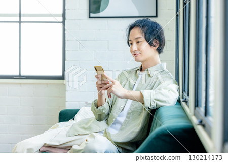 A man who uses a smartphone A man who uses a smartphone 130214173