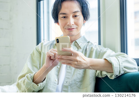 A man who uses a smartphone 130214176