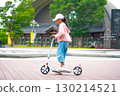 Asian girl is going to ride a scooter. Copy space 130214521