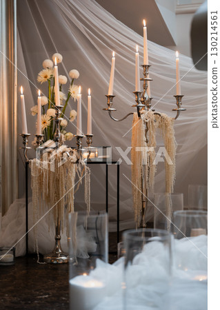 Elegant wedding reception decoration with candlelit centerpieces and flowers 130214561