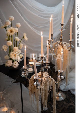 Elegant wedding reception decoration with candles and floral arrangements Elegant wedding reception decoration with candles and floral arrangements 130214568