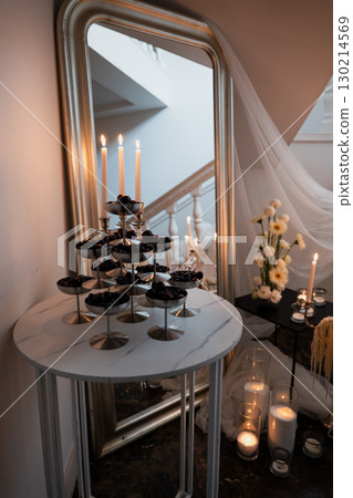 Elegant wedding reception decoration with mirror, candles and floral accents Elegant wedding reception decoration with mirror, candles and floral accents 130214569