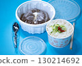 Kalguksu in a plastic box on a blue background. Food delivery 130214692