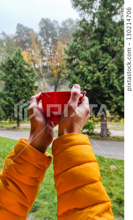 Tourist holding hot beverage enjoying autumn scenery in bohemian paradise 130214706
