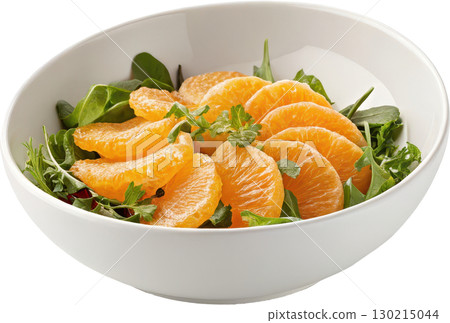 A vibrant and fresh orange and green leafy salad served in a clean white bowl 130215044