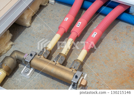 Detail of hot water pipes installed under the floor of an apartment building 130215146
