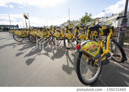rental bicycles on a sidewalk in Helsinki, Finland 130215489