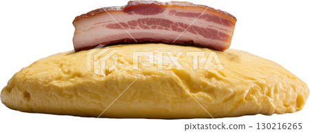 Thick slice of raw cured bacon rests atop a fluffy yellow omelette a hearty breakfast component 130216265
