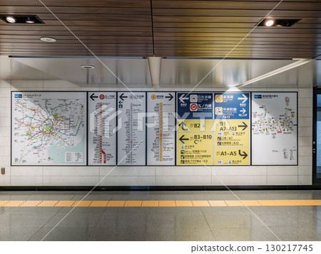 Subway station and nearby exit signs posted in an underground passageway in the city center 130217745