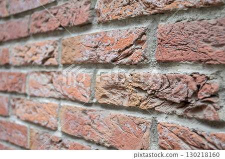 Brown structural stone wall of the ancient building consists of bricks. Nature structural background. Brown structural stone wall of the ancient building consists of bricks. Nature structural background. 130218160