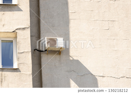 air conditioner is mounted on wall. technologies for air cooling in hot weather. air temperature 130218212