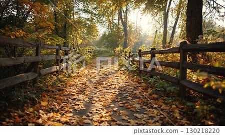 Path covered with fallen autumn leaves, rustic wooden fence on sides, 130218220