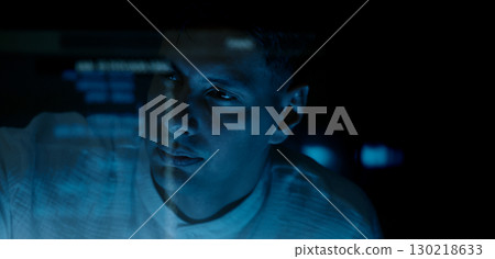 Programmers and coding. Programmer or Developer working in dark room with computer code reflected on their monitor. Cybersecurity software development and hacking idea. show coding digital technology. 130218633