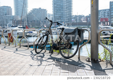 Modern bicycles on the street near the sea. Blue sea, houses and summer sky. Bike for sport or travel. Modern bicycles on the street near the sea. Blue sea, houses and summer sky. Bike for sport or travel. 130218720