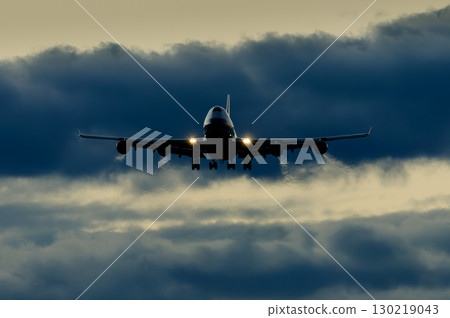 An airplane with a beautiful sunset, sky and clouds in the background 130219043