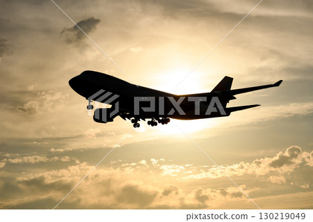 An airplane with a beautiful sunset, sky and clouds in the background An airplane with a beautiful sunset, sky and clouds in the background 130219049