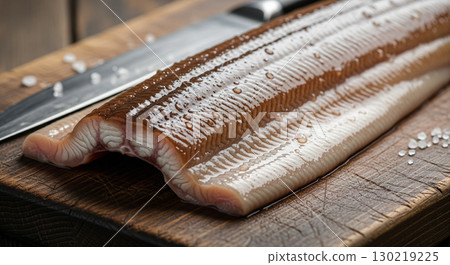 A Close Up of a Fresh Filleted Eel on a Wooden Cutting Board 130219225