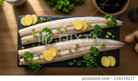 A Top Down View of Raw Eel Fillets with Ginger and Parsley 130219227