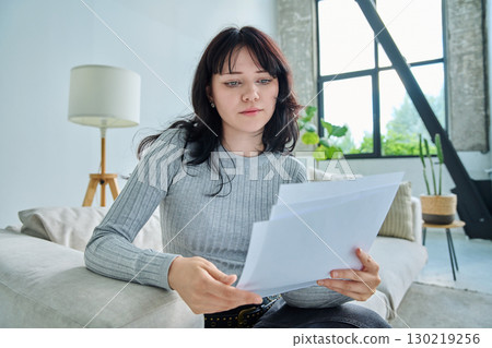 Web cam view of young woman with papers, online meeting, video call Web cam view of young woman with papers, online meeting, video call 130219256