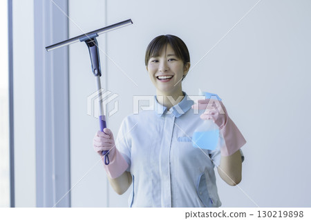 Portrait of a young female cleaner holding a squeegee Photo courtesy of Tokyo Electronics College, Denpa Gakuen Corporation Portrait of a young female cleaner holding a squeegee Photo courtesy of Tokyo Electronics College, Denpa Gakuen Corporation 130219898