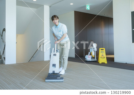A young female cleaner vacuums the floor of an office building. Photo courtesy of Tokyo Electronics College, Denpa Gakuen Corporation A young female cleaner vacuums the floor of an office building. Photo courtesy of Tokyo Electronics College, Denpa Gakuen Corporation 130219900