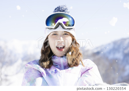Cute woman enjoying the snowy mountains Cute woman enjoying the snowy mountains 130220354