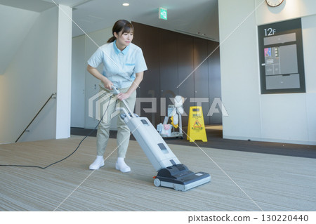 A young female cleaner vacuums the floor of an office building. Photo courtesy of Tokyo Electronics College, Denpa Gakuen Corporation A young female cleaner vacuums the floor of an office building. Photo courtesy of Tokyo Electronics College, Denpa Gakuen Corporation 130220440
