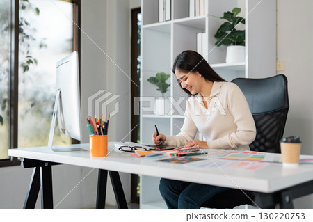 Graphic design process with a smiling professional in a creative workspace Graphic design process with a smiling professional in a creative workspace 130220753