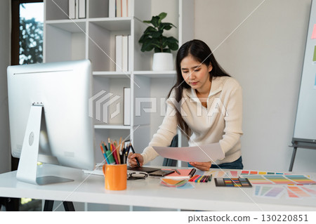 Creative graphic design process with color palettes, sketches, and digital tools. 130220851