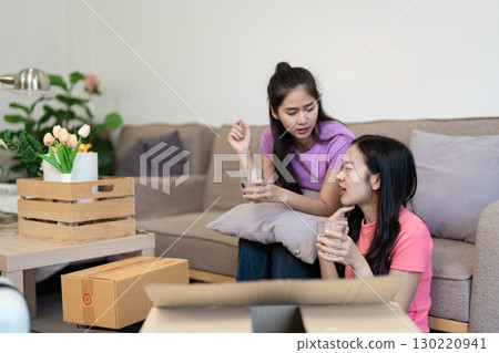 Casual conversation A lesbian couple sharing drinks in their new home Casual conversation A lesbian couple sharing drinks in their new home 130220941