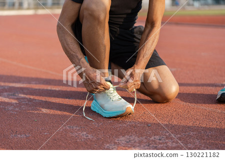 Active Senior Tying Running Shoes on Track Promoting Health and Wellness in Retirement Lifestyle Active Senior Tying Running Shoes on Track Promoting Health and Wellness in Retirement Lifestyle 130221182