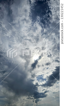 Dark blue clouds and sunlight in the sky Dark blue clouds and sunlight in the sky 130221452