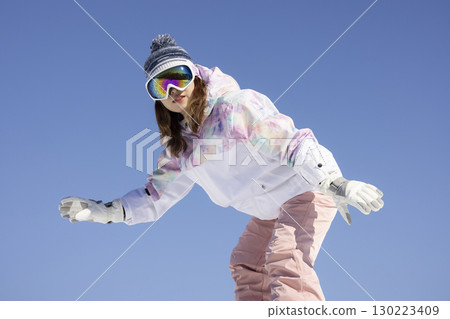 Cute woman enjoying snowboarding Cute woman enjoying snowboarding 130223409