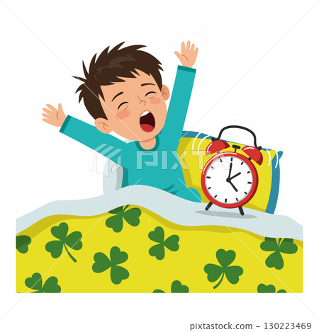 Boy yawning waking up in bed with alarm clock and clover patterned blanket vector illustration 130223469