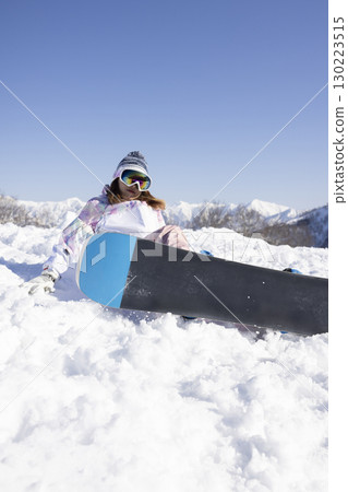 Cute woman enjoying snowboarding Cute woman enjoying snowboarding 130223515