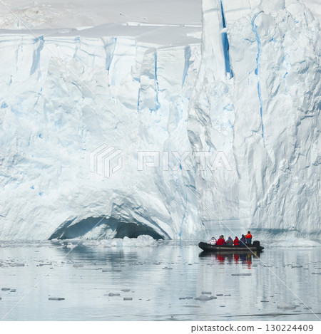 Tourists observing a glacier on the Antarctica, Paradise bay, Antartic Peninsula. 130224409