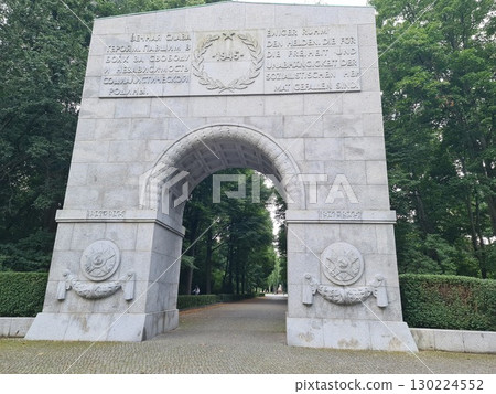 Berlin, Germany - August 1, 2025: Triumphal arch made of gray granite at the entrance to the Soviet memorial in the Treptower Park Berlin, Germany - August 1, 2025: Triumphal arch made of gray granite at the entrance to the Soviet memorial in the Treptower Park 130224552