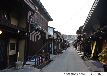 Old townscape of Takayama City, Gifu Prefecture, Japan. Old houses exuding a sense of history. Morning scene during the Takayama Spring Festival. 130224639